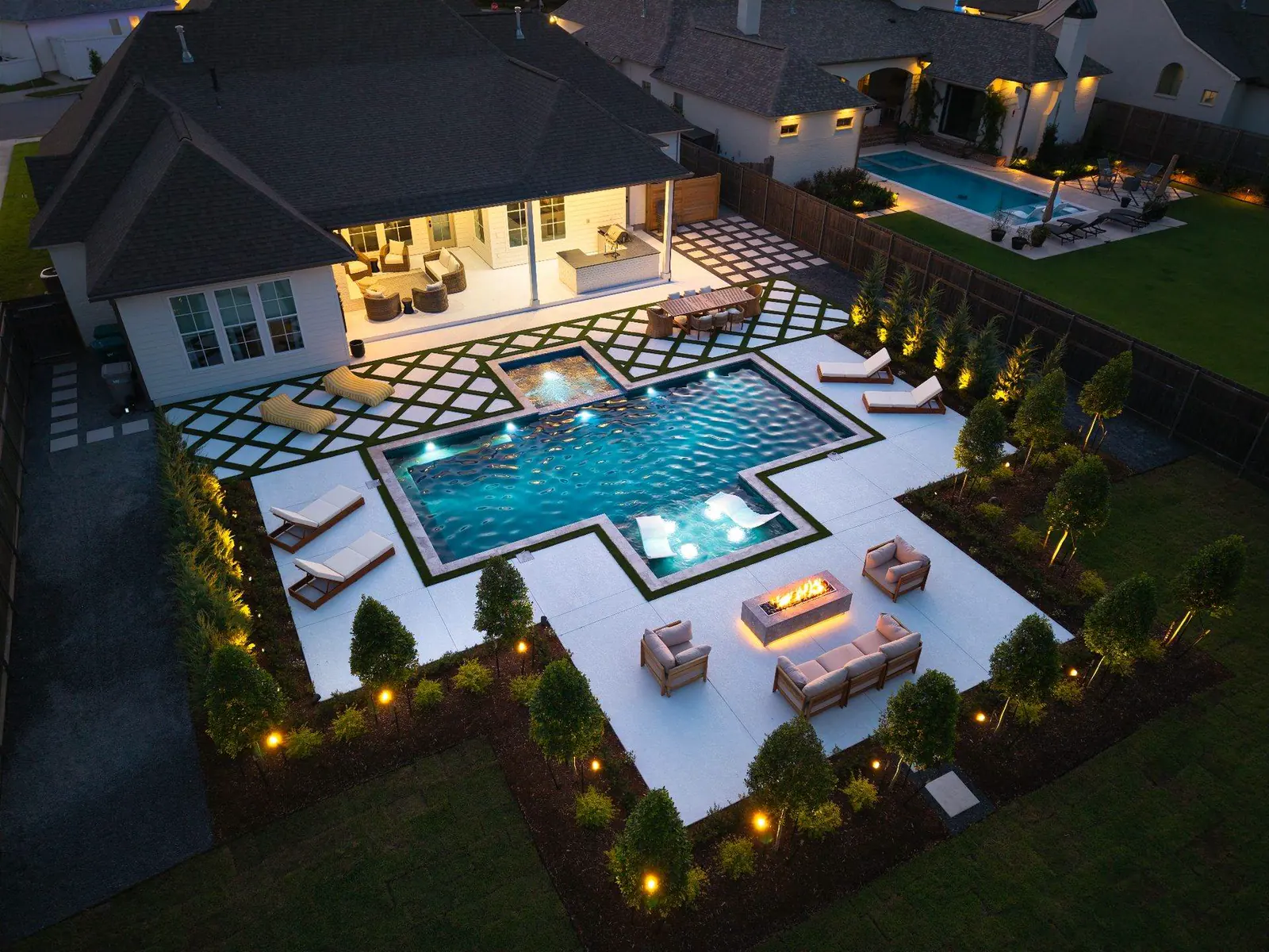 Drone view of a Breaux Bridge backyard with a pool, artificial turf, and a wood pergola